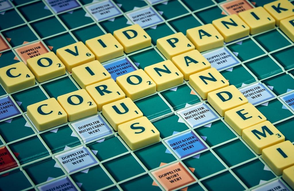 Scrabble game showing the words covid, virus, corona and pademic