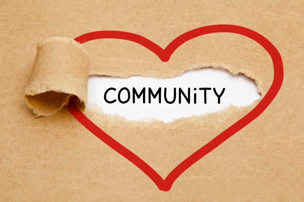 the word community is written in a heart