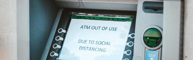 ATM with a message that reads "out of use due to social distancing"