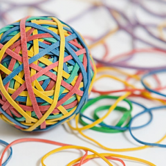 ball of entangled colorful elastic rubber bands